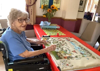 Resident doing a puzzle at Rose Cottage in Huntingdon, Cambridgeshire